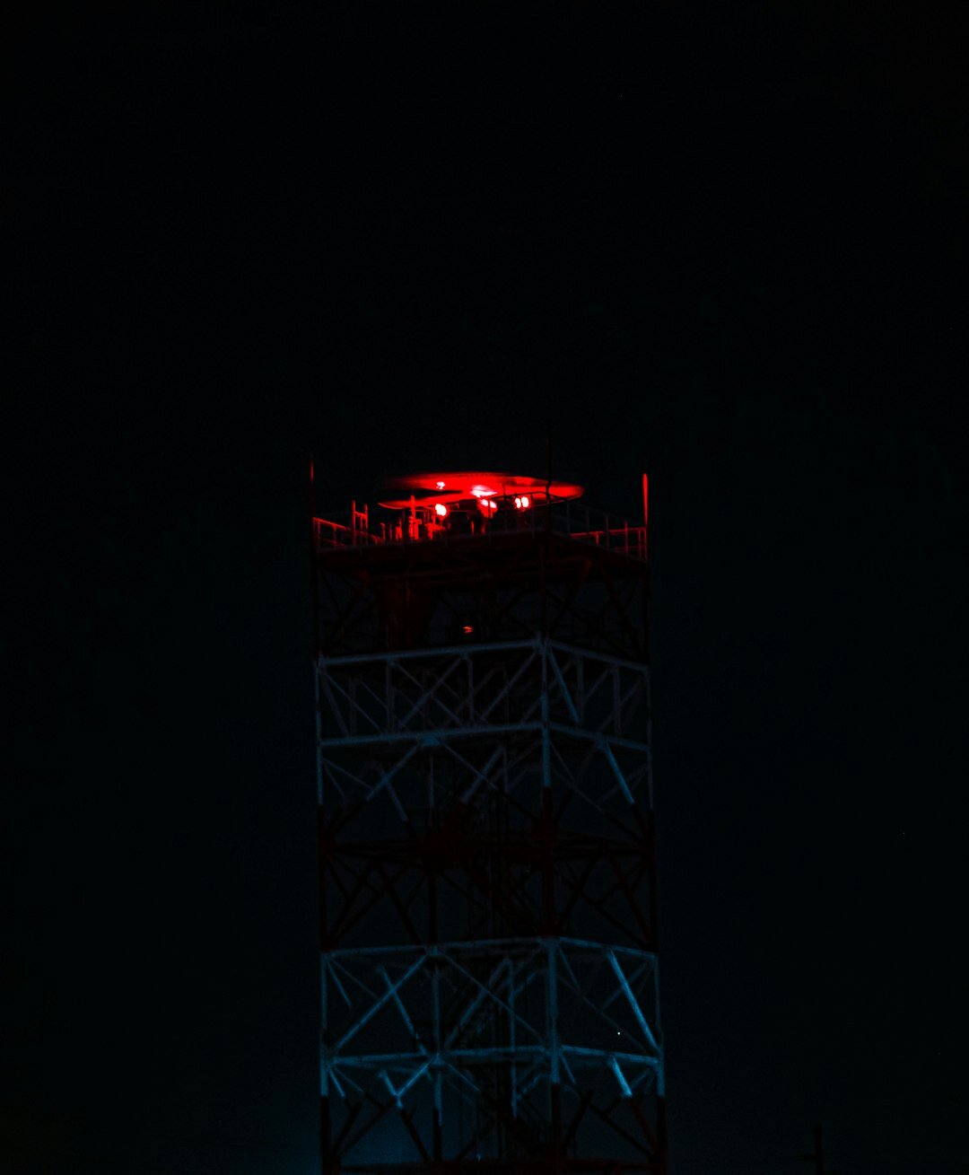 Broadcast transmission tower at night with signal lights